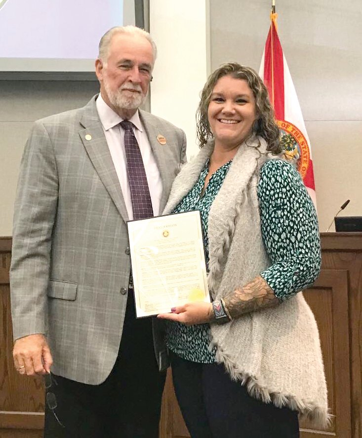OKEECHOBEE -- Veterans Services Officer Sarah Carter (right) accepted the proclamation for Operation Green Light for Veterans from Commission Chairman Terry Burroughs (left) at the Oct. 20 meeting of the Okeechobee County Board of Commissioners in the Historic Okeechobee County Courthouse. [Courtesy photo]
